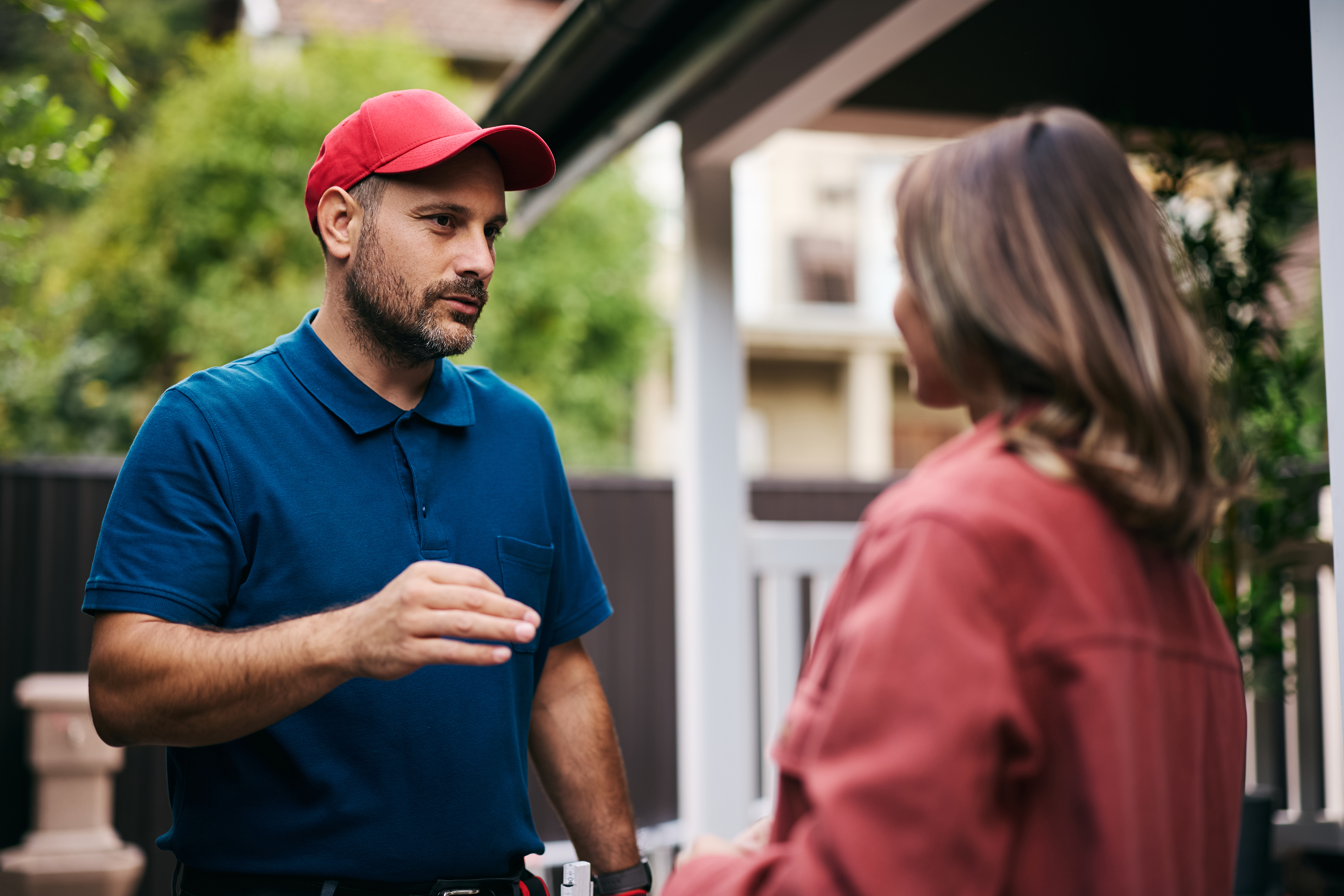 Solo service professional speaking with a homeowner outside